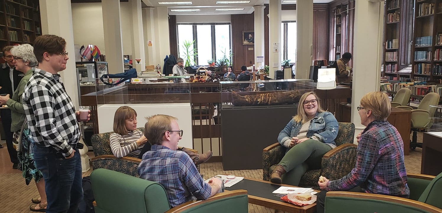 Photograph of students talking and laughing together in the library's main floor