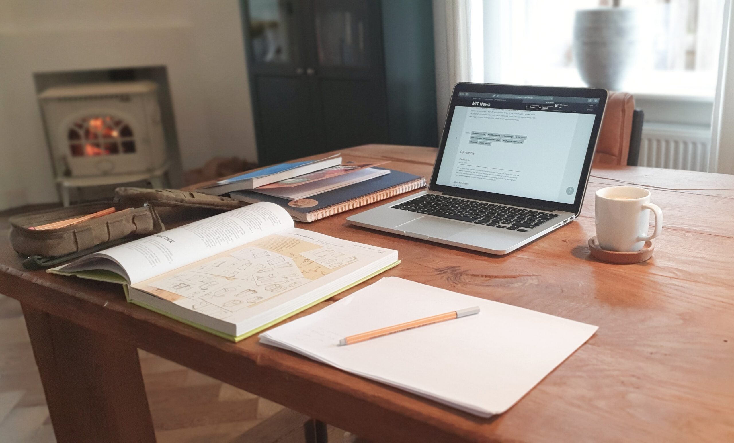 stock photo of a table spread with study materials, coffee, and a laptop