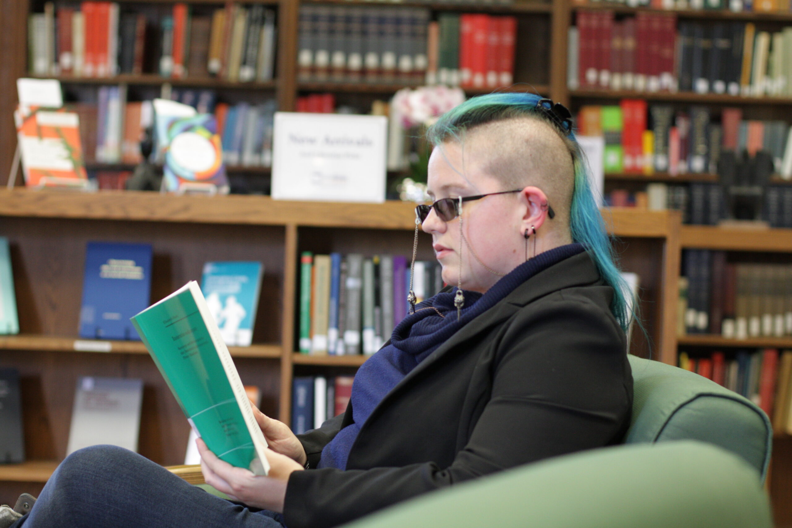 Photo of student reading a book in Styberg Library