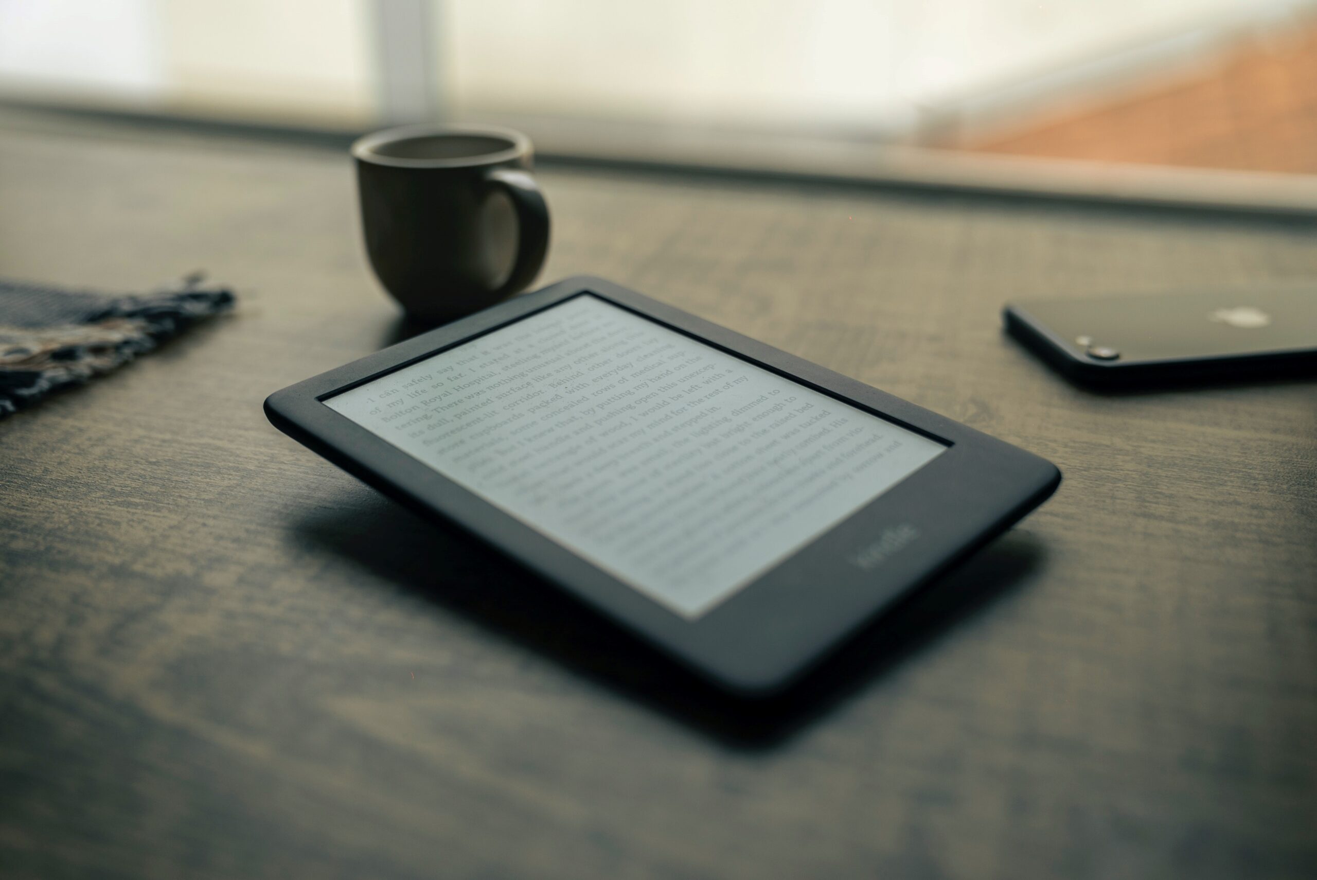 Stock image of an E-Reader and coffee cup